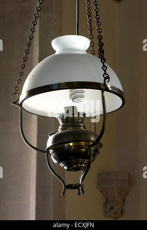 Light with spiral energy saving bulb, St. Andrew`s Church, Great Rollright, Oxfordshire, England, UK Stock Photo
